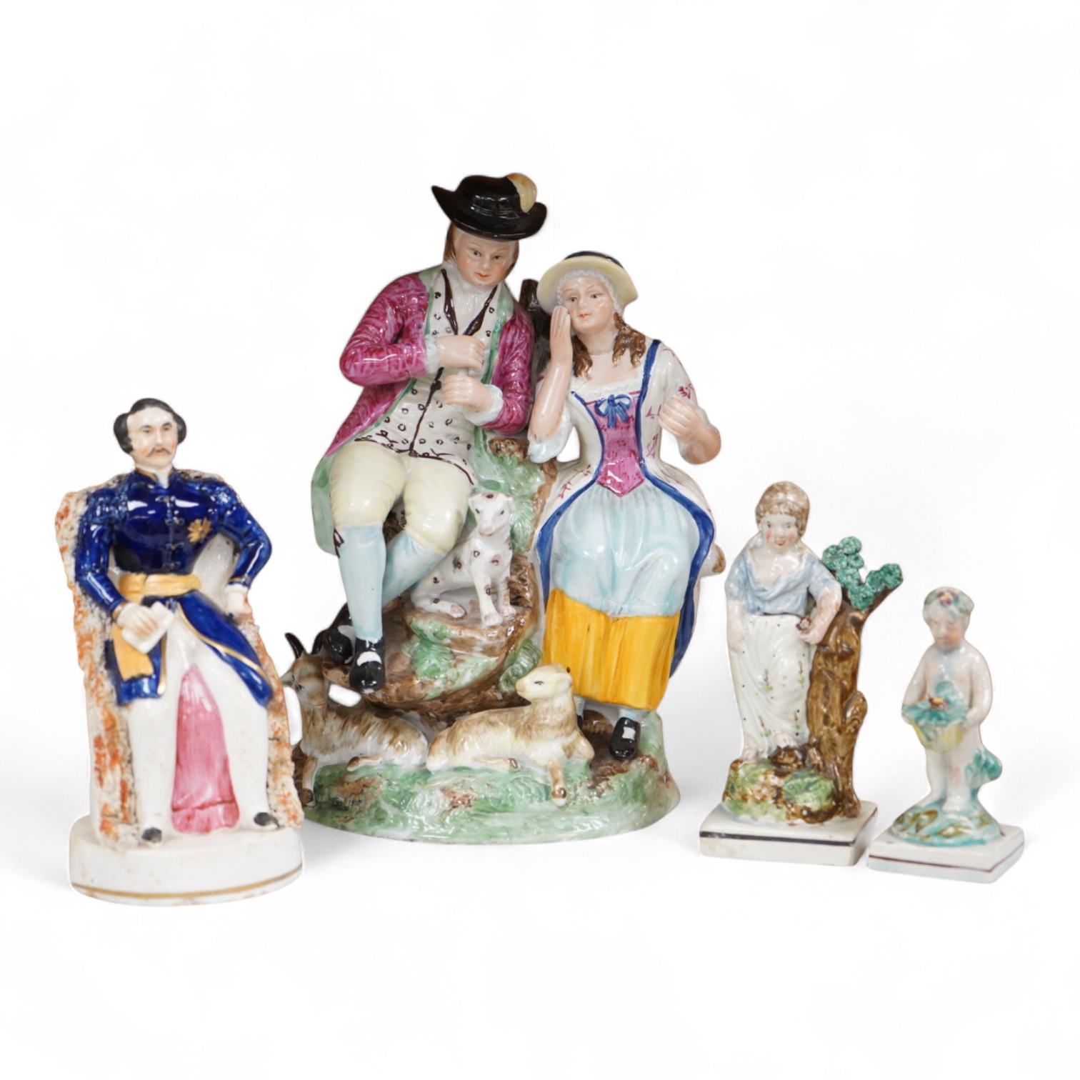 A Ralph Wood style group and three Staffordshire figures, largest 26cm high